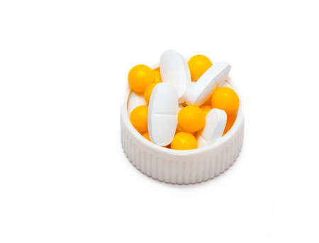 yellow and white pills on whiteの写真素材