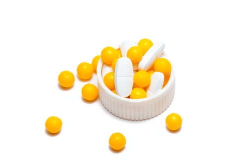 yellow and white pills on whiteの写真素材