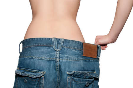 young girl measures the blue jeans, large sizeの写真素材