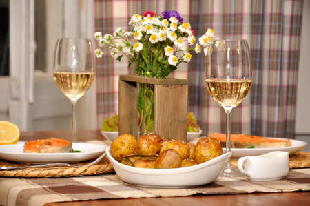 table with potatoes, fish and wine