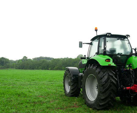 Tractor on green field isolated on white sky