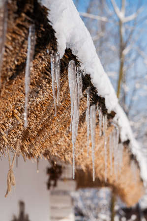 beautiful icicles hanging on roofの写真素材