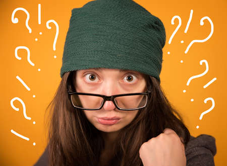 the girl with glasses and hat on a yellow backgroundの写真素材