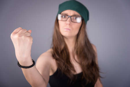 angry girl on gray backgroundの写真素材