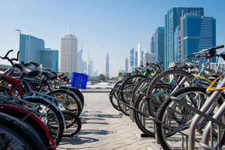 DUBAI, UAE -  6 MARCH, 2014: Bicycle parking on a background of modern skyscrapers of Dubai. March ...