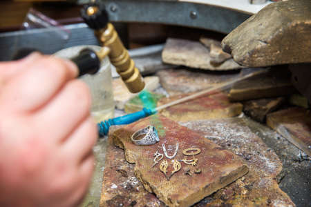 jeweler produces gold jewelry
