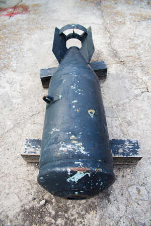 big old black bomb on asphaltの写真素材