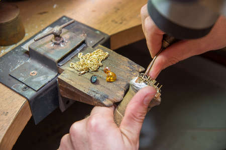 jeweler fixes gems on gold product