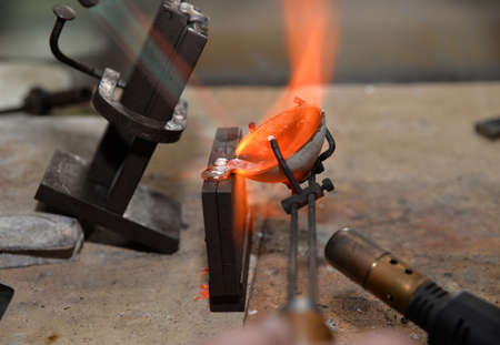 jeweler melts precious metal burner