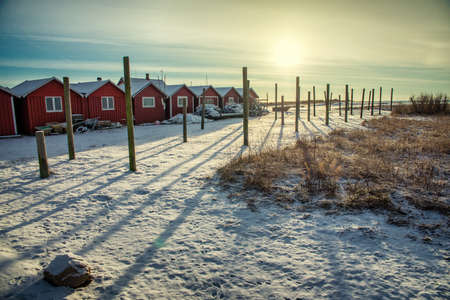 winter sunrise over the red houseの写真素材