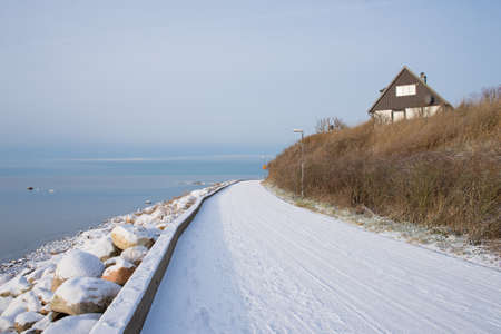 Road near the sea in winter in Swedenの写真素材