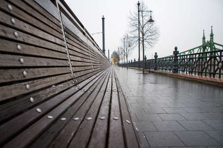 An empty bench in the rain in Budapest