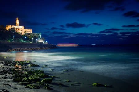 view of the old city of Jaffa from the coast in Tel Aviv at nightの写真素材