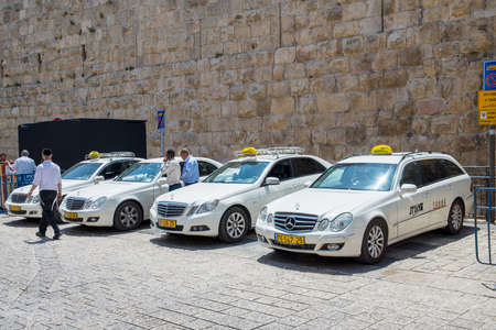 JERUSALEM, ISRAEL - JUNE 1, 2015: Taxi waiting for passengers near the old city walls. June 1, 2015. Jerusalem, Israel.のeditorial素材