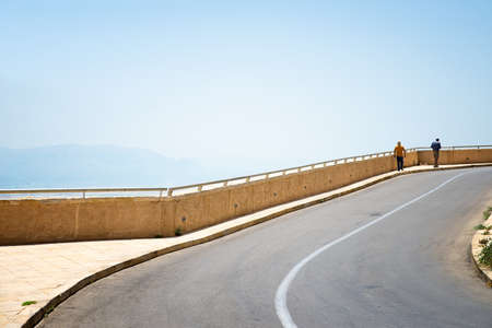 people go along the asphalt roadの写真素材