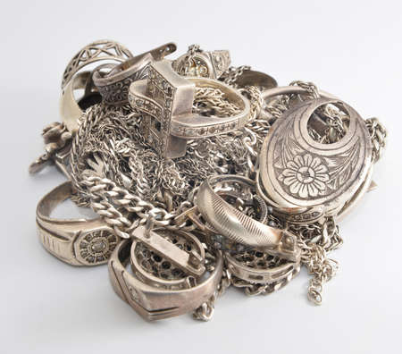 gold and silver jewelry on a light backgroundの写真素材