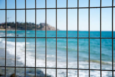 iron fence against the seaの写真素材