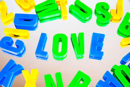 word love from plastic letters on a white backgroundの写真素材