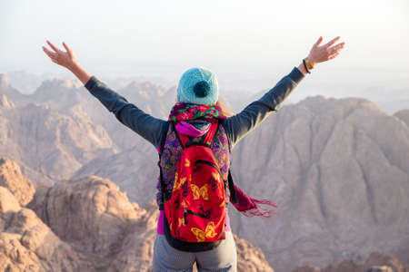 Girl looks at Sinai mountains at dawn