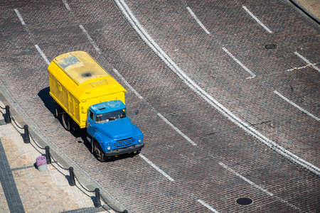 Yellow truck on the road view from aboveの写真素材
