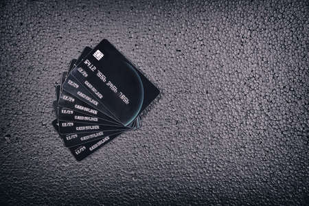 Black credit cards on black backgroundの写真素材