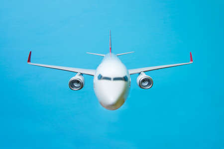 white airplane on a blue background, front view