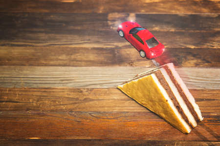 toy car jumping from the springboard in the form of a cakeの写真素材
