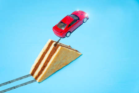 toy car jumping from the springboard in the form of a cakeの写真素材