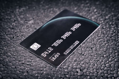 Black credit card on black backgroundの写真素材
