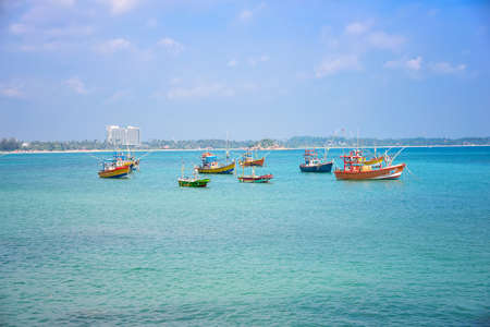Colorful fishing boats in the harbor waiting for fishermen.の写真素材