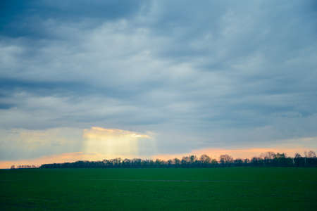 Landscape, green field and blue cloudsの写真素材