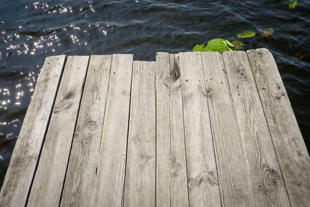 wooden plank on the background of waterの写真素材
