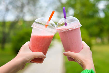 Strawberry smoothies in the hands of a girlの写真素材