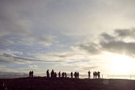 Tourists against the background of sunrise in the Thingvellir National Park