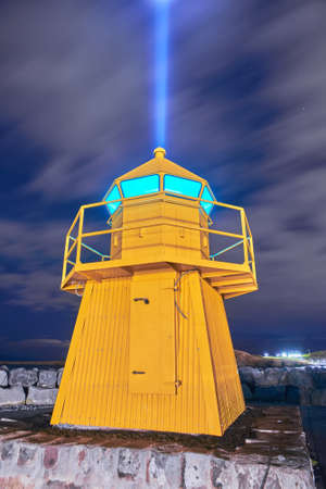 Lighthouse and Imagine Peace Tower on Videy island in Reykjavik at nightの写真素材