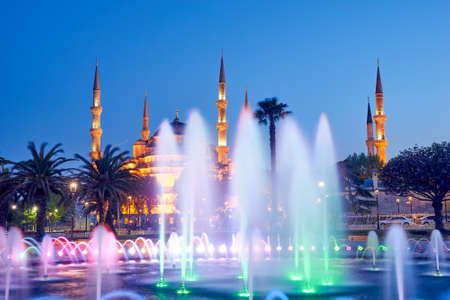 Fountain and The Sultan Ahmed Mosque in Istanbul during sunsetの写真素材