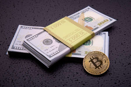 golden coin bitcoin  and dollars on black background