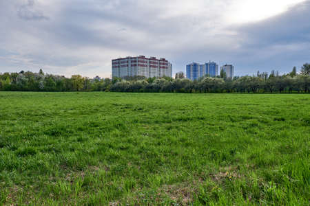 Large modern residential building and green fieldの写真素材