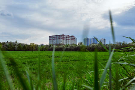 Large modern residential building and green fieldの写真素材