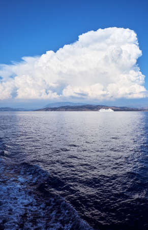 A large cloud over the islands in the Ionian Sea and a cruise linerの写真素材