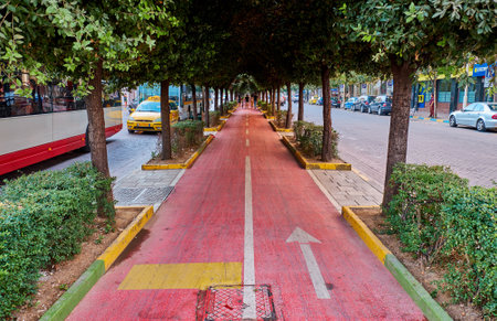 TIRANA, ALBANIA - AUGUST 9, 2018: Red bicycle road in the city centerのeditorial素材