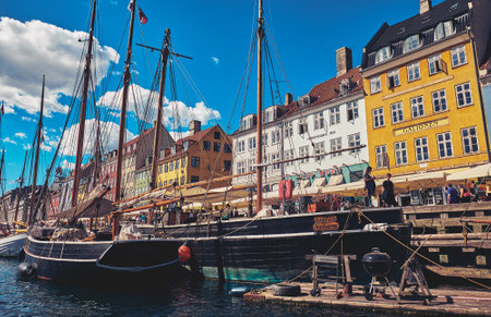 Denmark, Copenhagen - July 2, 2018: Nyhavn is a 17th-century waterfront, canal and entertainment...