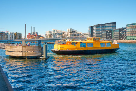 Denmark, Copenhagen - July 1, 2018: city ferry approaches the shoreのeditorial素材