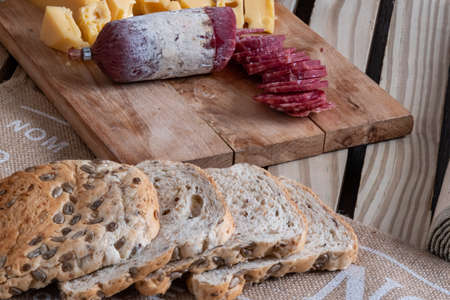 Cheese, sausage and homemade bread with flax and sunflower seeds to taste