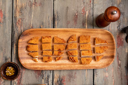 rich fried chicken lunch with rice cooked in olive oil and with pepper and sunflower seedsの写真素材