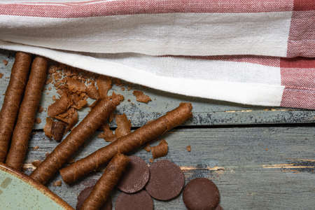 Chocolate cookies, on rustic wood next to cocoa in different formsの写真素材