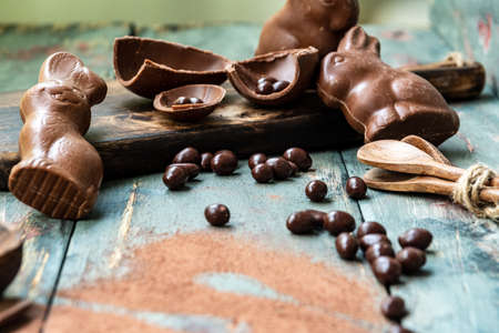 dark chocolate of different shapes on rustic wood to eat at special parties