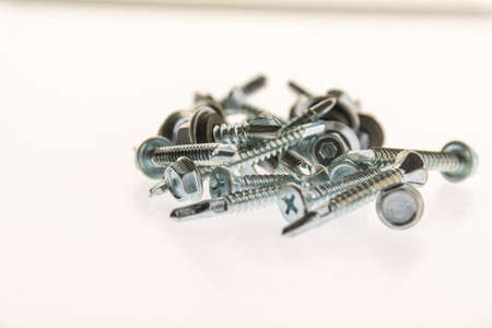 sheet metal and stainless steel screws together with nutsの写真素材
