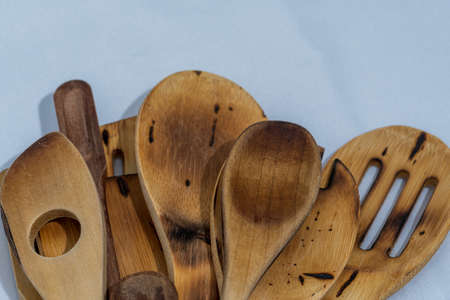 rustic wooden utensils on white tablecloth background for home cooking
