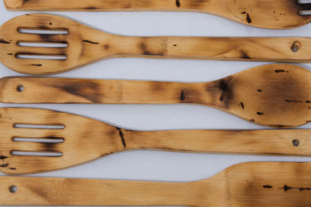rustic wooden utensils on white tablecloth background for home cooking